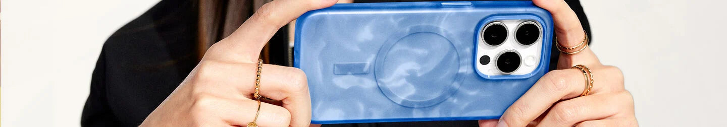 Woman holding stylish blue and white swirled OtterBox Figura Series Artist Collection for iPhone 15 Pro Max