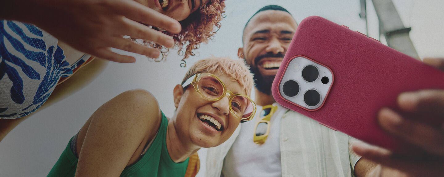 Group of friends taking selfies on iPhone 16 Pro Max in pink OtterBox Symmetry Series Cactus Leather phone case