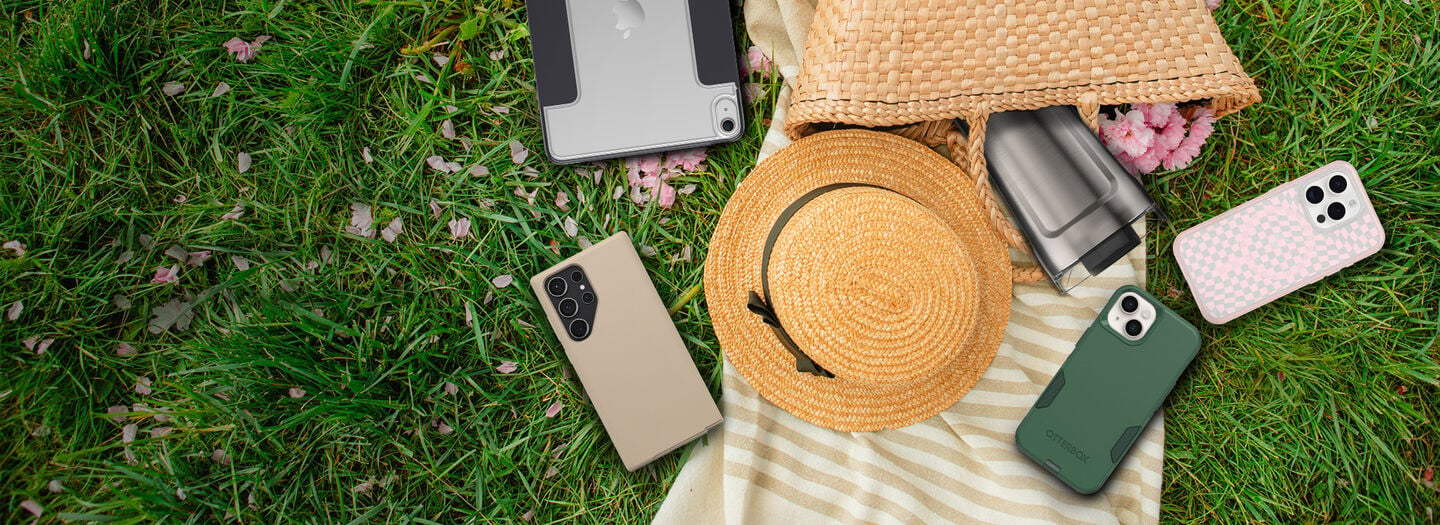 Variety of protective and colorful OtterBox cases for iPhone, iPad and Samsung Galaxy devices on a picnic background