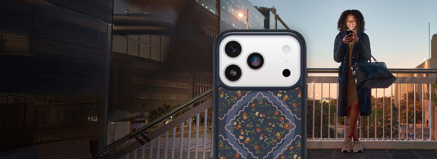 Trendy person standing in the background with iPhone 17 Pro Symmetry Series floral case in the front and center.