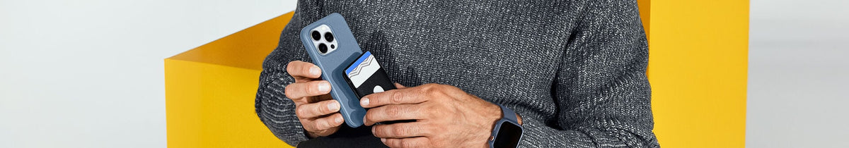 Man attaching black OtterBox MagSafe Wallet on a blue MagSafe OtterBox iPhone case