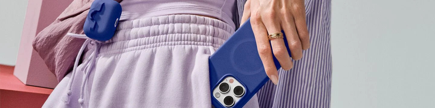 Woman with blue OtterBox AirPods case and matching blue OtterBox protective iPhone case for iPhone 16 Pro Maxd 