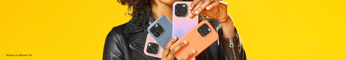 Person holding three smartphones with a yellow background