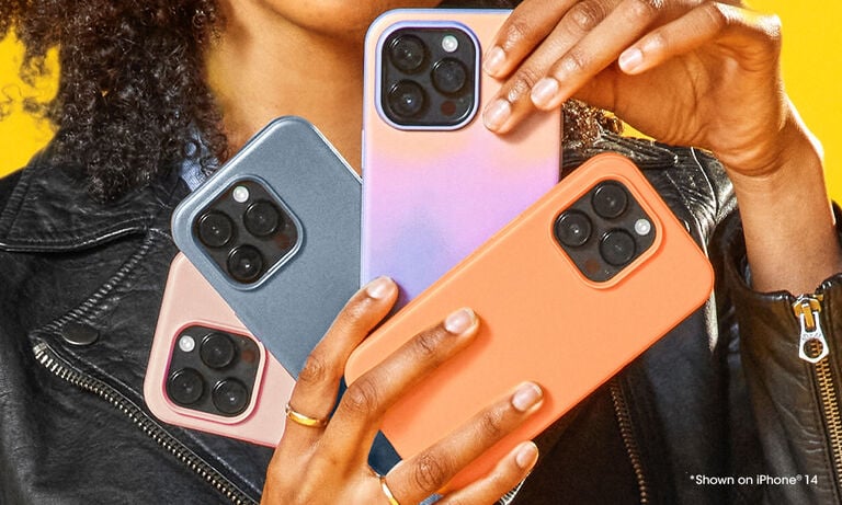 Person holding four different colored phone cases on an iPhone 14.