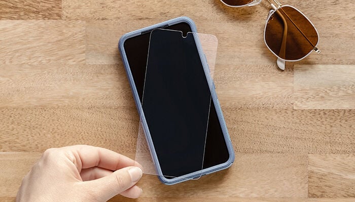 Phone case on a wooden surface with sunglasses in the background