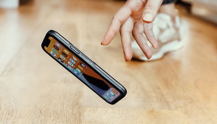 Phone case with visible branding on a wooden surface