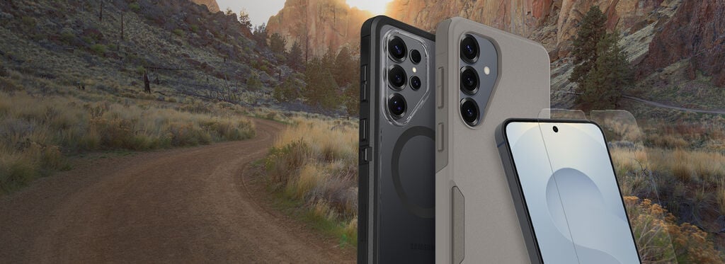 Two smartphones, one black and one gray, with a scenic background of a desert landscape.