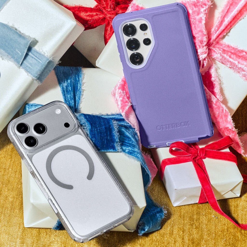 Two phone cases, one purple and one clear with a logo, on a decorative background with wrapped gifts.