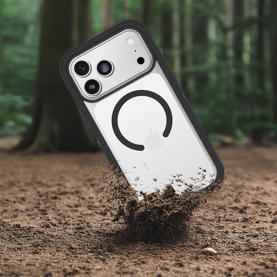Clear phone case with black accents in dirt against a forest background.