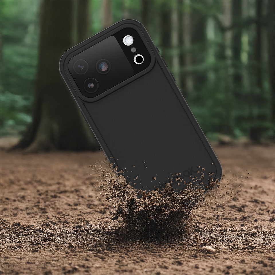Black phone case being dropped onto dirt with a forest background