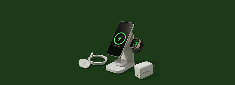 Wireless charging stand with smartphone, smartwatch, and earbuds on a green background