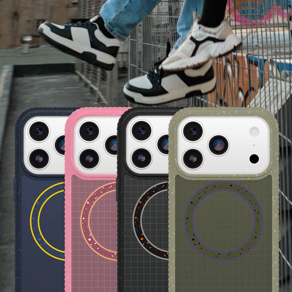 Four phone cases with different designs in front of a person wearing sneakers.