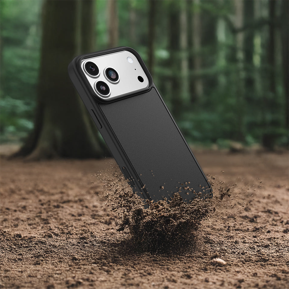 Phone case being buried in dirt with a forest background