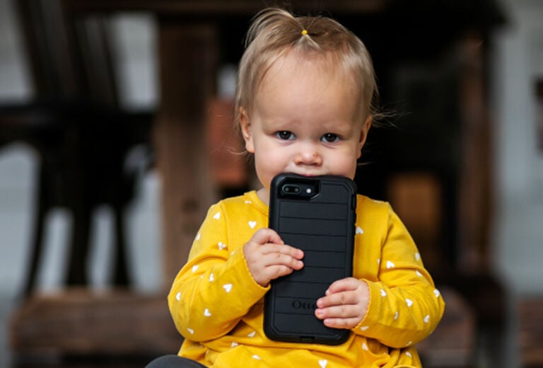 Baby biting black OtterBox Defender Series case