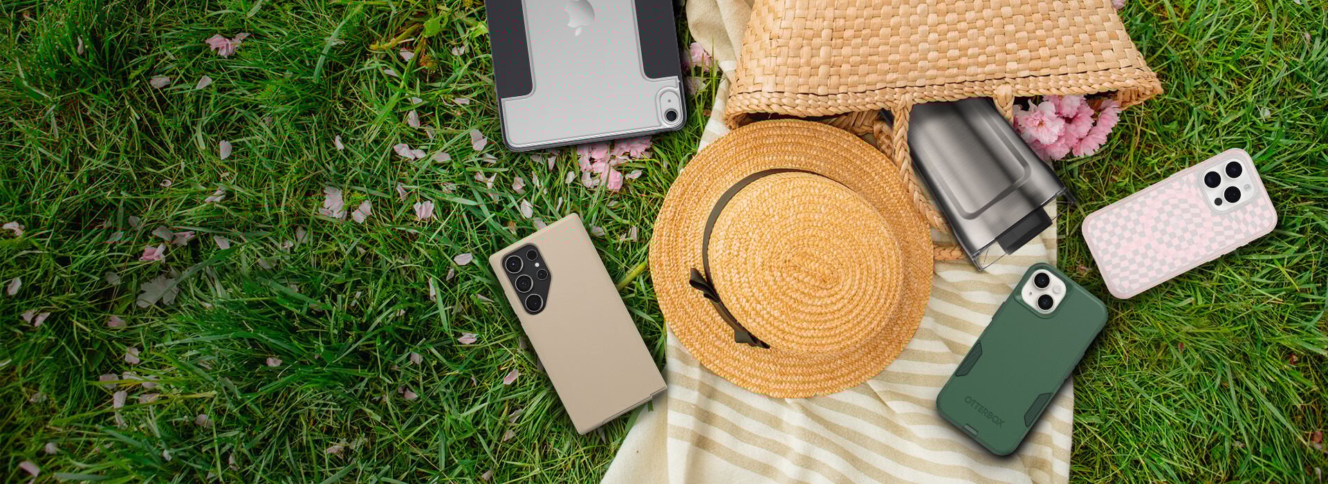 samsung galaxy and iphones spread out on a picnic blanket